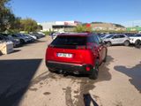 a red car that is parked in a parking lot