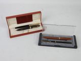 a pen and a pen holder in a box