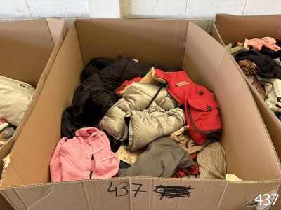 two cardboard boxes filled with clothes sitting on top of a floor