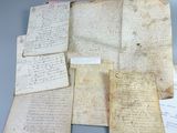 several old papers are sitting on top of each other on a table