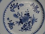 a blue and white plate with flowers on it