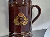 a person holding a brown coffee mug on a table