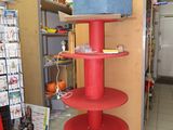 a red shelf with a blue box on top of it