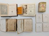 several old books sitting on top of each other on a table