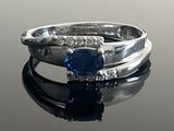 a ring with a blue stone and diamonds on it