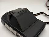 a polaroid camera sitting on top of a white table