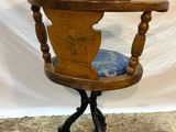 an old wooden chair with a blue cushion sitting on top of it