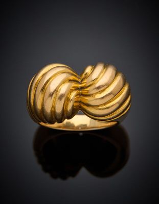 a close up of a gold ring on a black surface