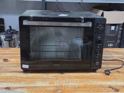 a microwave that is sitting on a wooden table