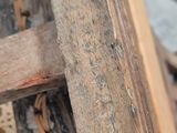 a close up of a wooden bench with a chain on it