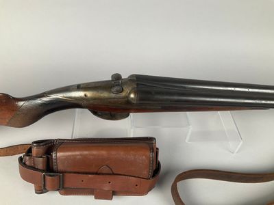 an old gun with a leather case and a leather belt