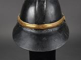 a close up of a helmet on a stand on a black surface