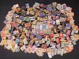 a pile of old matchboxes sitting on a table
