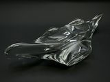 a glass bird that is sitting on a black surface