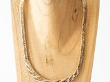 a close up of a wooden mannequin with a rope on it