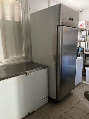 stainless steel refrigerator and freezer in a kitchen with tiled flooring