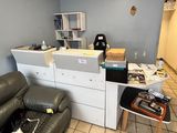 a room with a couch, a desk, and a printer