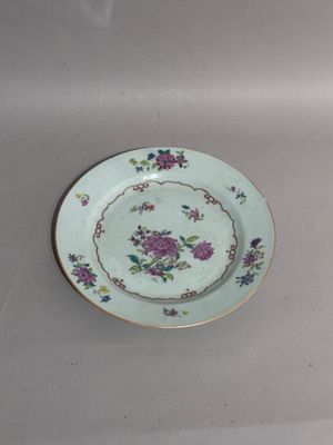 a plate with a flower design on it on a table