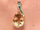 an image of a close up of a woman ' s neck with a necklace with a yellow topazne