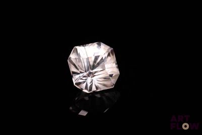 a close up of a diamond on a black surface
