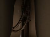 a close up of a sink in a dark room with a faucet