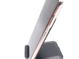 a cell phone that is sitting on top of a stand
