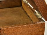 a small wooden box with a lid open on a table