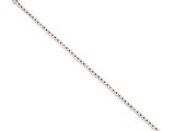 a close up of a silver bracelet with red stones on it