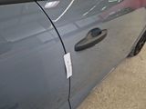 a close up of a car door handle with a sticker on it