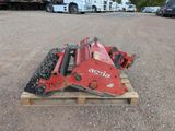 an image of a red skid steer on a pallet