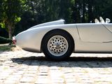 a white sports car parked on a cobblestone road