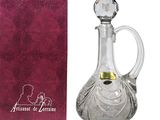 crystal wine decanter with a pink cloth next to it