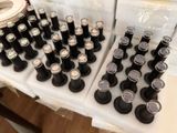 bottles of wine are lined up on a table with a roll of ribbon