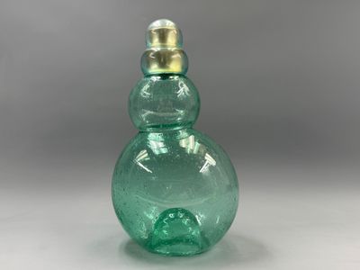 an image of a green glass bottle with a gold top