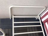 a picture of a white towel rack on a tiled floor