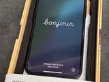 an iphone is sitting in a box with a pen on top of it