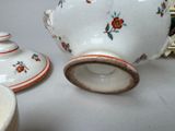 two cups and a saucer sitting on a table
