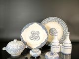 several pieces of blue and white china sitting on a black table
