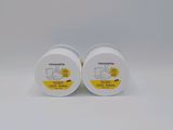 a pair of white plastic containers with yellow labels on them