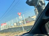 dashboard of a car with a view of a street sign from inside of the car