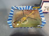 a yellow helicopter in a box on a table