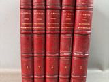 a set of five red books sitting on top of a white surface