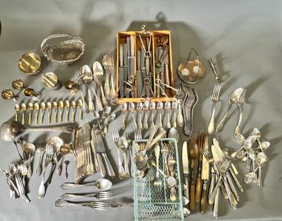 a lot of silverware on a table with a basket