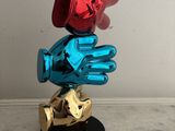 a statue of a person with a glove on top of it