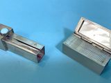 pair of silver plated lighters on a blue surface