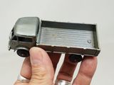 a person holding a toy truck in their hand