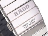 a close up of a watch on a white surface