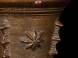 a bronze vase with a star design on it