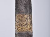 a close up of a sword on a stand against a white background