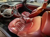 a picture of a car with red leather seats and a steering wheel
